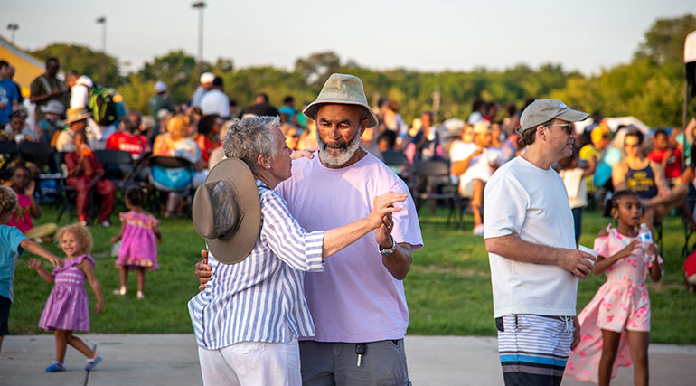 A couple dancing  at a festival.