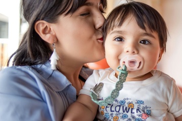 Parent holding a baby.