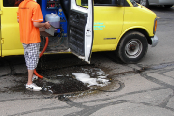 Liquid leaking from a truck onto the pavement.