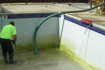 Person draining swimming pool