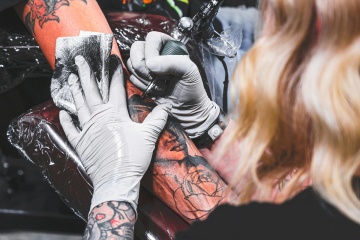 Person getting a tattoo.