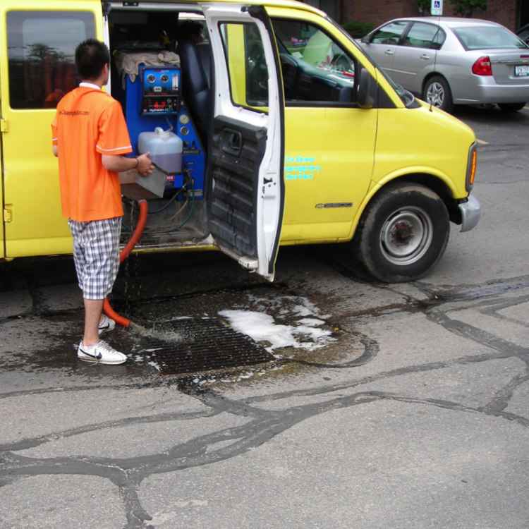 Carpet cleaning wastewater being dumped into a storm drain.