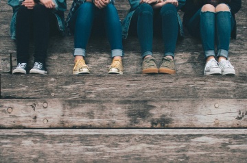 Shoes of teens sitting on steps
