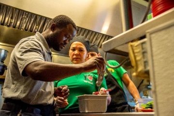 A sanitarian checking the temperature of food in a restaurant.