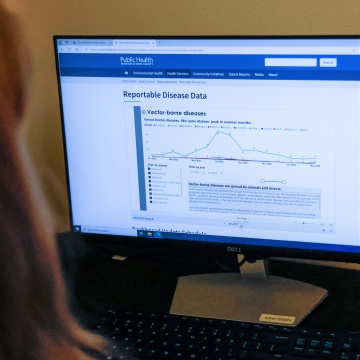 Person looking at a computer screen.