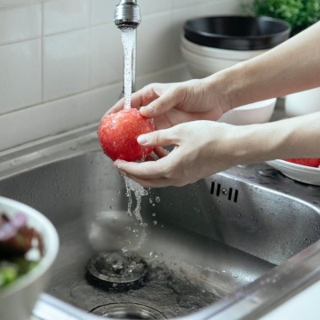 washing an apple in the sink