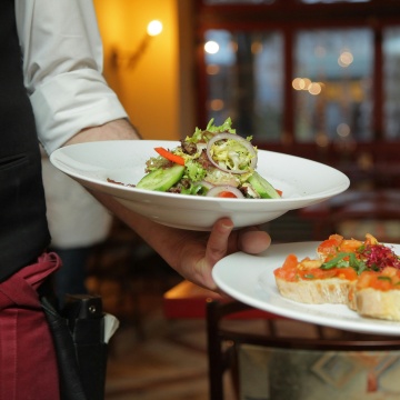 Person holding a bowl of food.