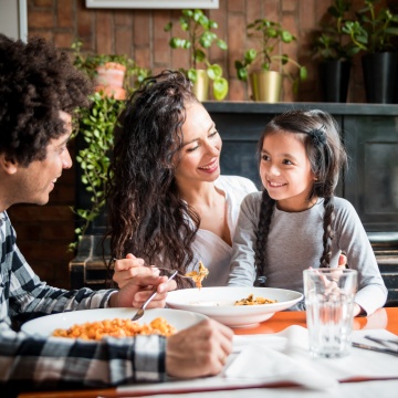 child adults sitting table food