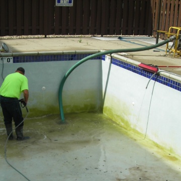 Person draining swimming pool