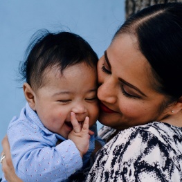 Parent kissing baby's cheek