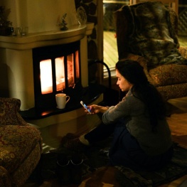 person sitting next to fireplace